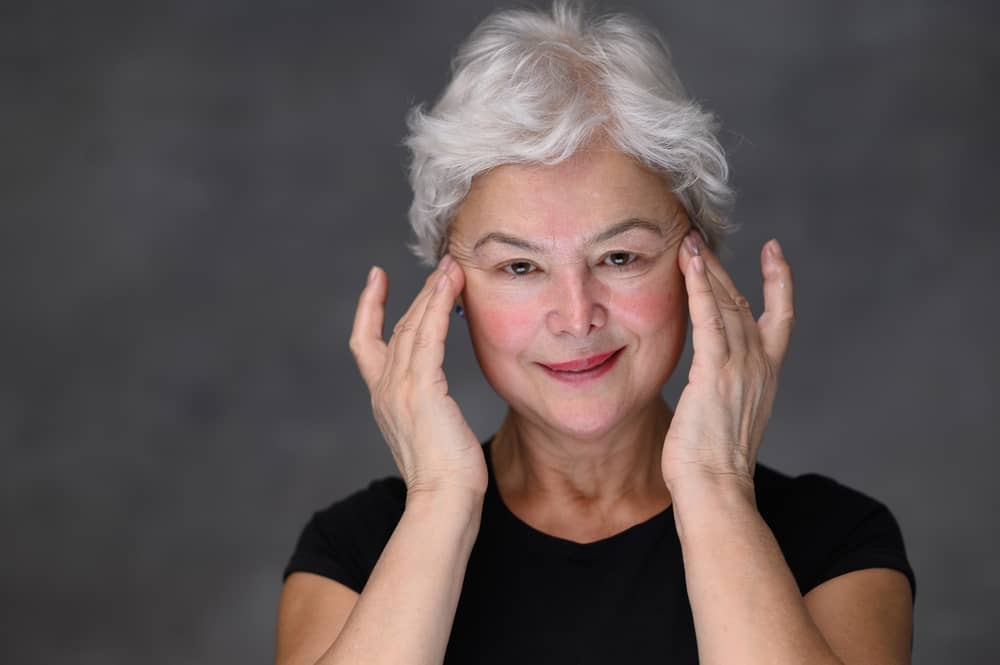 Mature woman lifting her face in relation to Botox