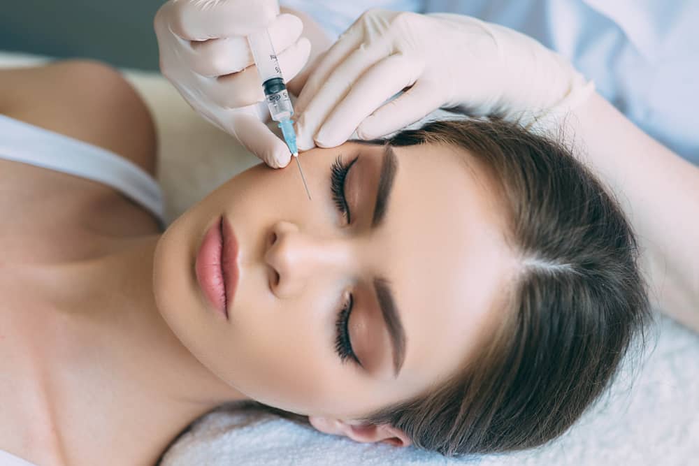 Female patient receiving Botox under the eyes