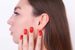 Close-up of an ear post-otoplasty, highlighting recovery stages under Dr. Swartout's care.
