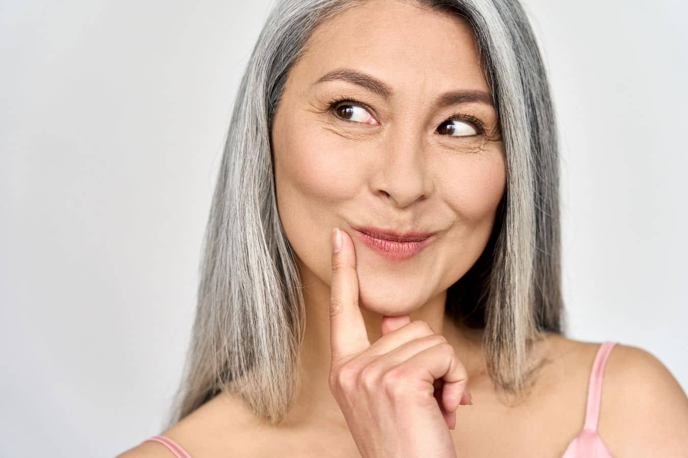 Confident woman with smooth under-eye area, highlighting natural-looking eye rejuvenation with Botox in Beverly Hills